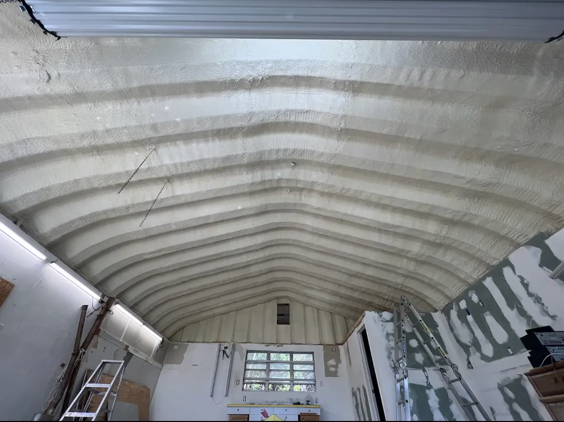 Spray polyurethane foam applied to the underside of a metal roof deck in Modesto